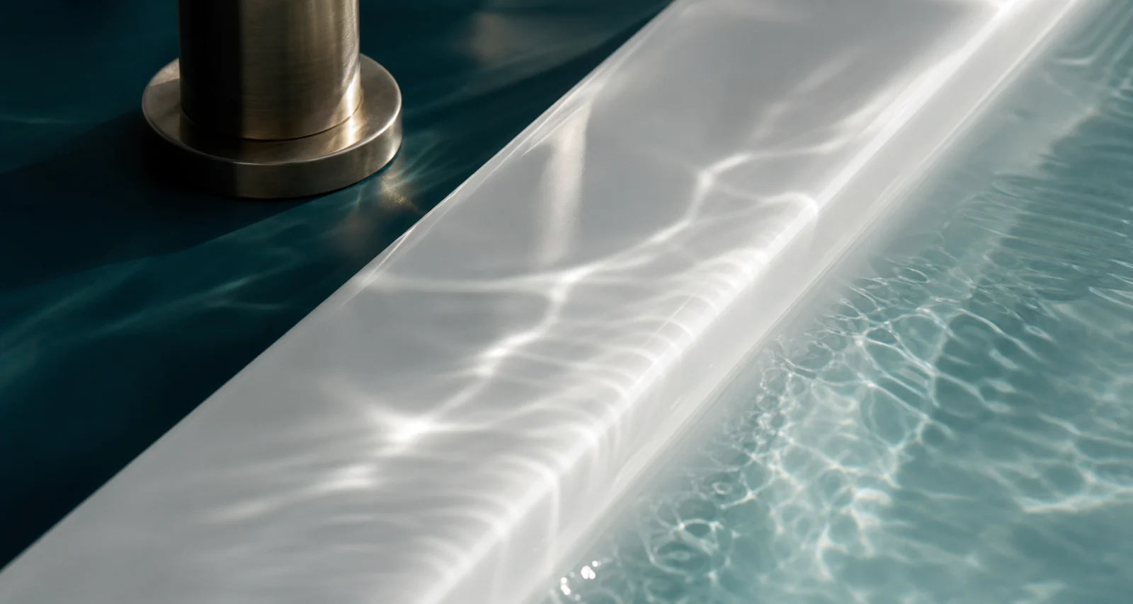 Clear water reflecting light across a porcelain basin